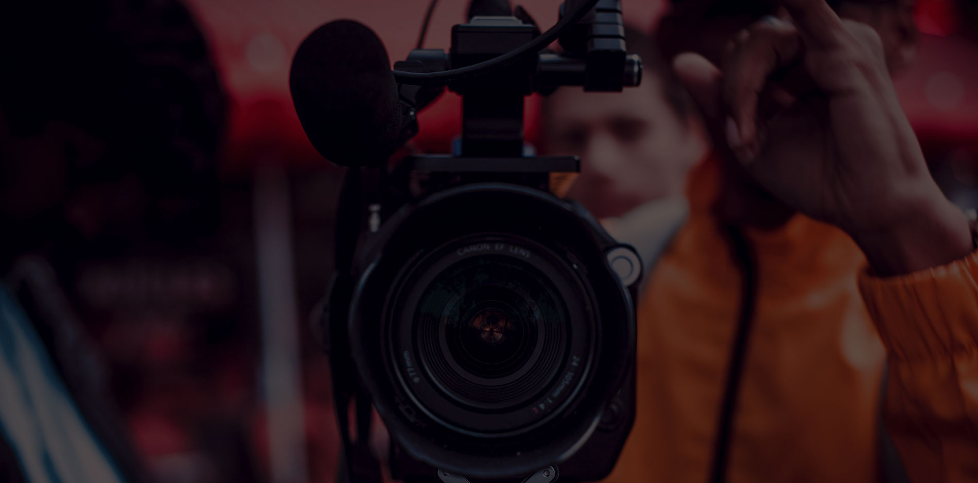 Camera lens with crew in background